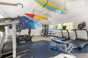 A gym with a surfboard mural on the wall.